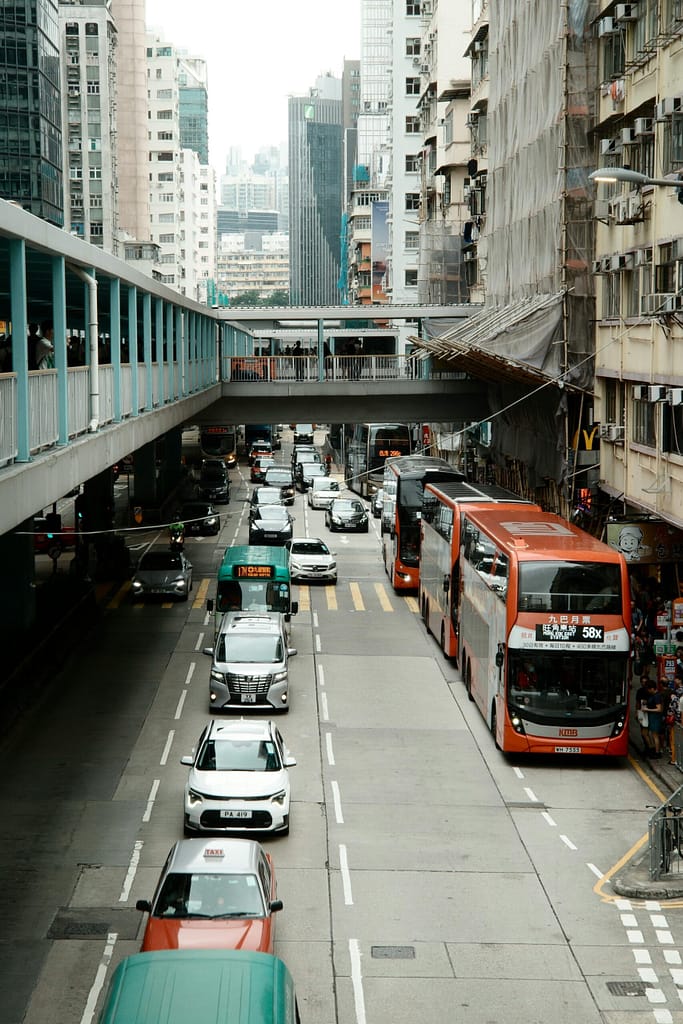 Busy Hong Kong street scene featuring double-decker buses and urban traffic on a typical city day.